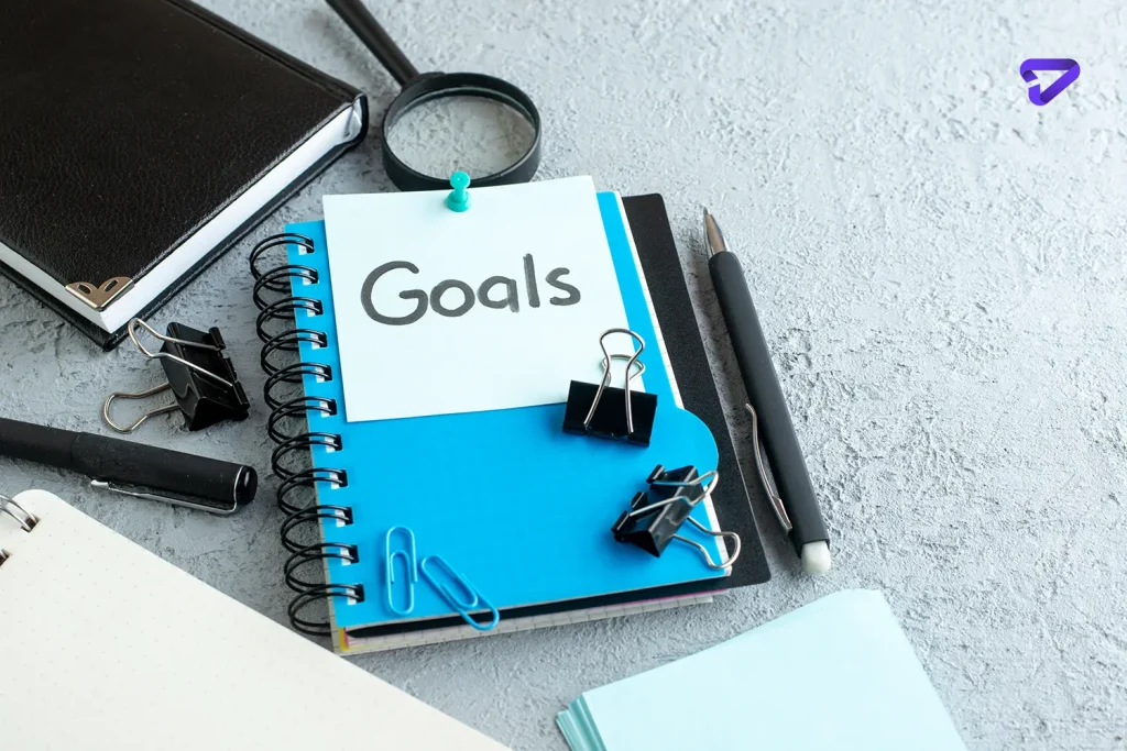 front view goals written note with notepad pen white background copy